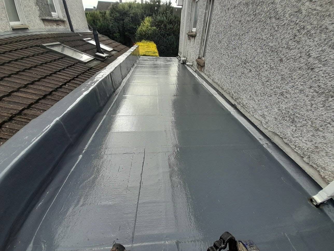 the outside of a house in Dublin with a new roof being installed and scaffolding around the house