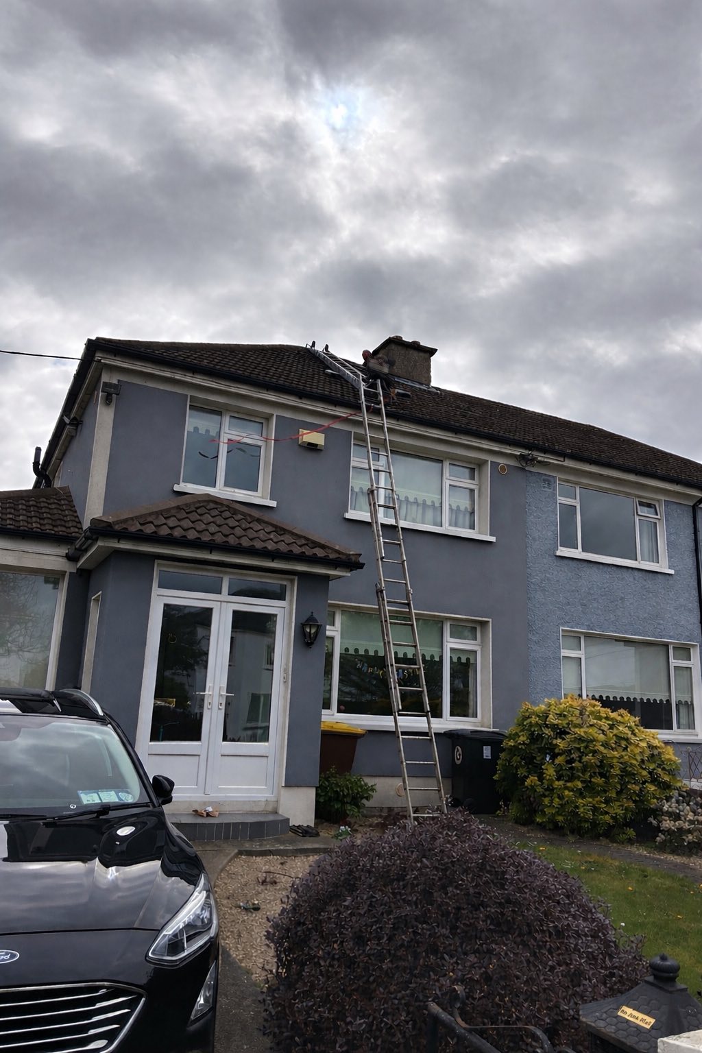 the outside of a house in Dublin with a new roof being installed and scaffolding around the house