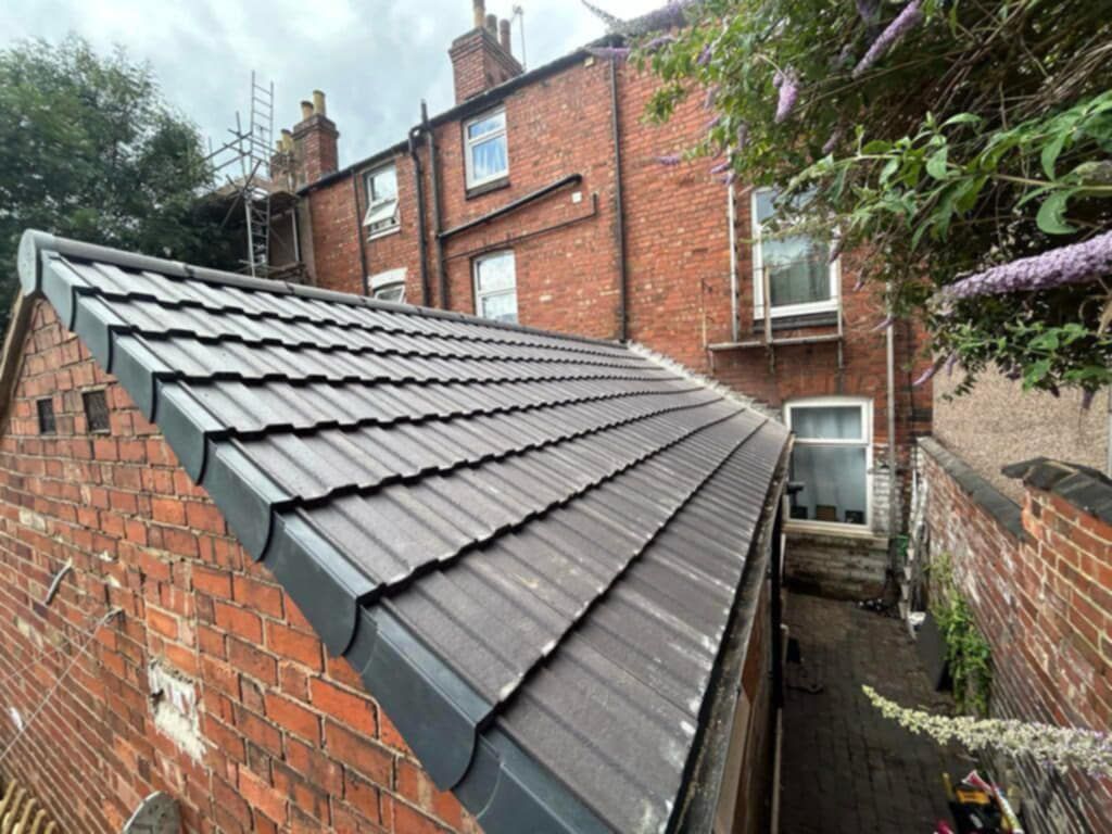 side view of an extension at the back of a house with the dry verge system and roof tiles visible.
